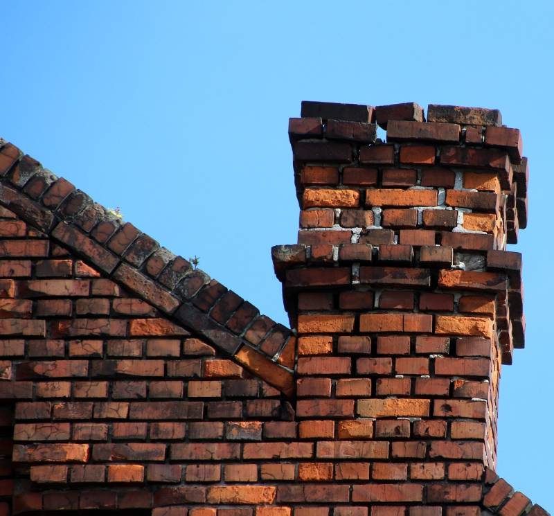 Signs Your Country Club Home Needs a Chimney Inspection Damaged chimney on an Country Club home showing cracks and missing mortar